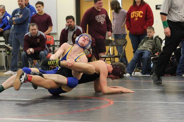 Daniel Raynor leg rides is opponent to the mat. /Courtesy • Tim Grady