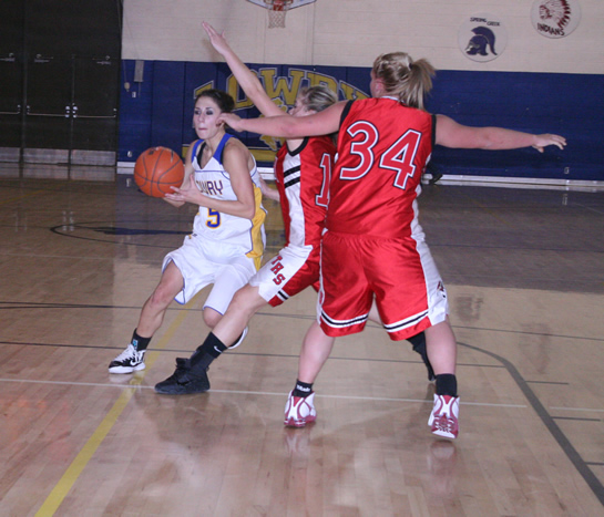Madi Gonzalez drives the ball through some Wooster defenders. /Courtesy • Winnada