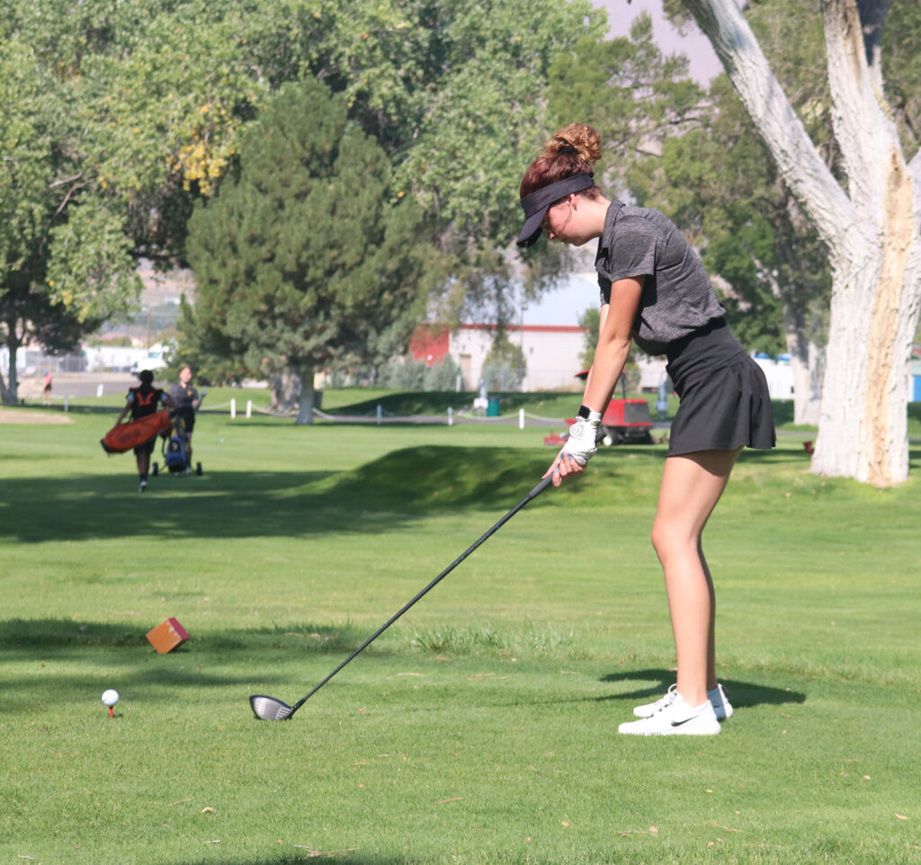 Bailey Hayes gets ready to tee off during the home tournament her senior year./ Maddi McClure • The Brand