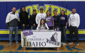 Jovi Kuskie with family and coaches as she signs with the college of Idaho. /Ron Espinola • The Brand