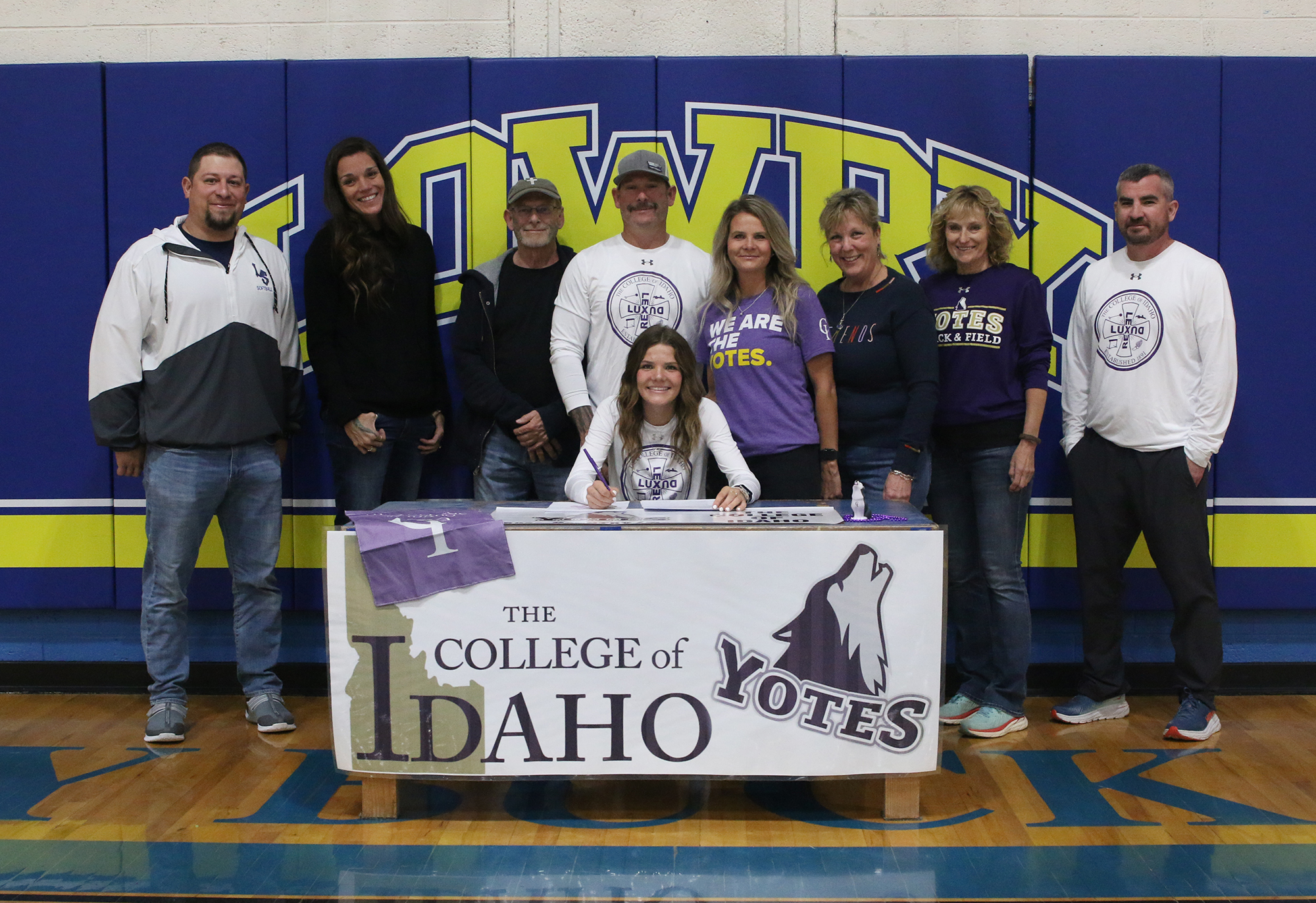 Jovi Kuskie with family and coaches as she signs with the college of Idaho. /Ron Espinola • The Brand