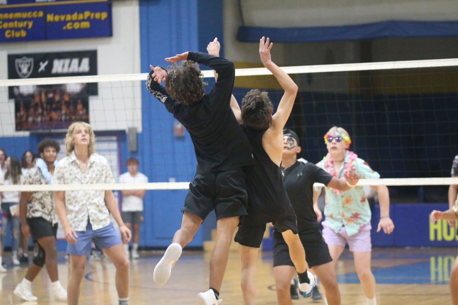Freshmen Ryan Bales and Txema Beongochea jump for the ball in a he-man volleyball match against the Juniors. /Alexa Toscano • The Brand