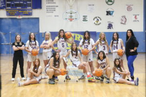 This year’s women’s varsity basketball team rounds up for a team photo. /Olivia Espinola • The Brand