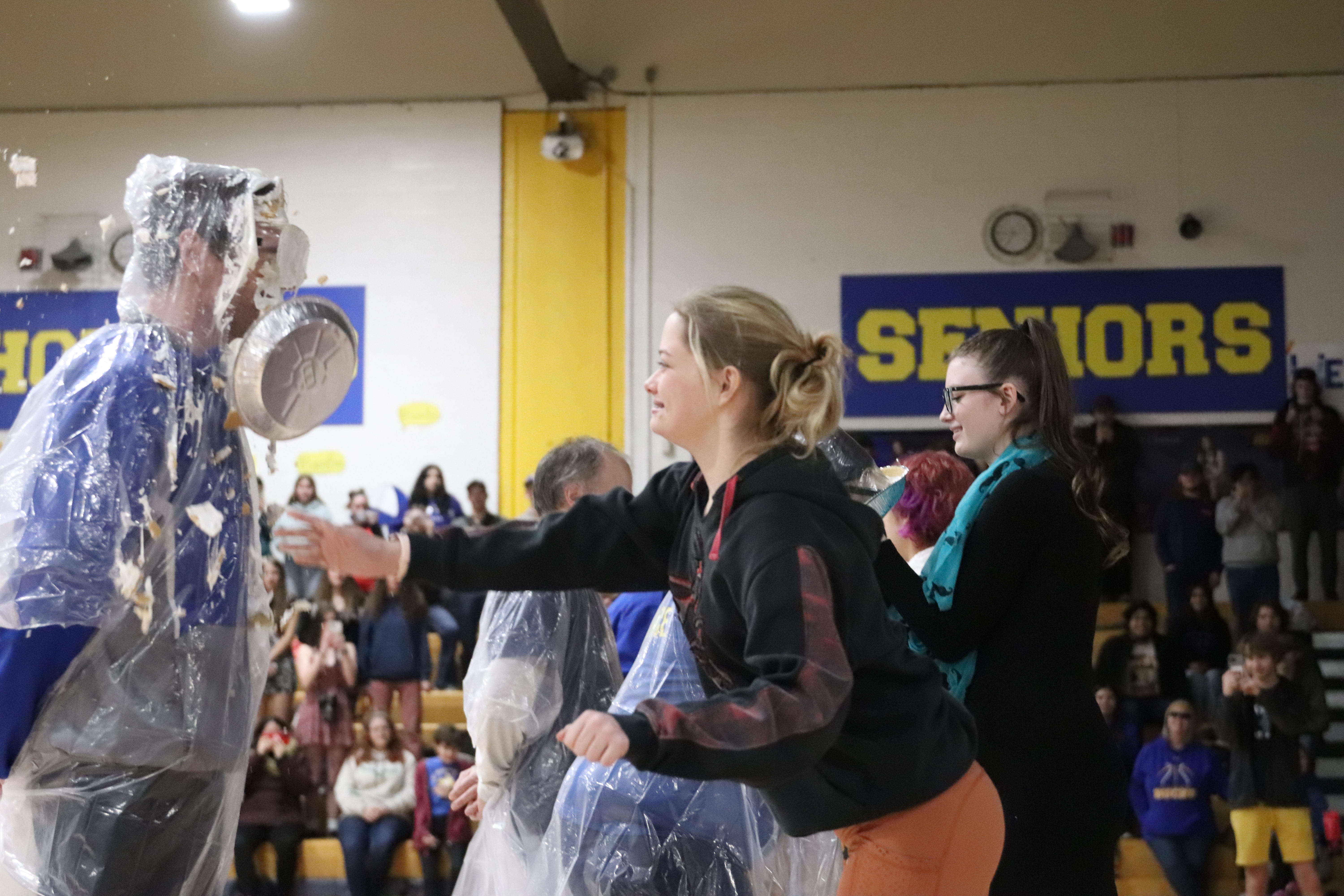Aiden Peters throws a pie at
Mr. Grant Beatty during Friday’s
assembly./ Lainey Novacek •
The Brand