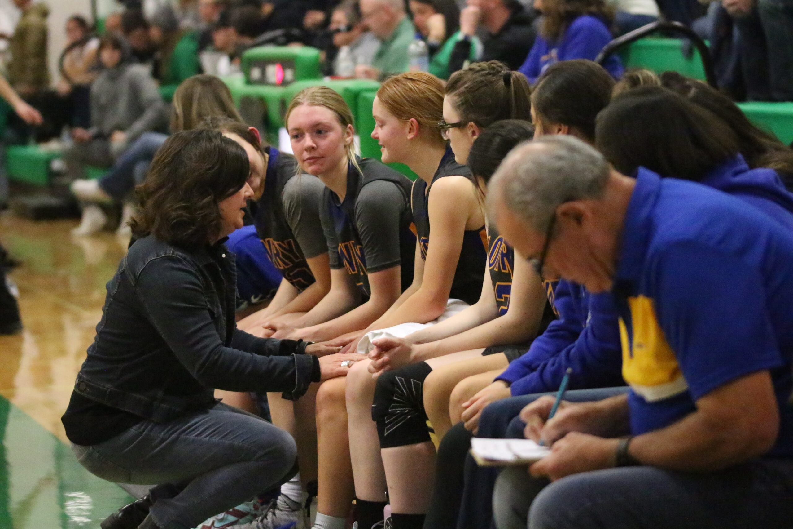 Assistant Coach Debbie Connors talks to players on the bench. /Danielle Scott • The Brand
