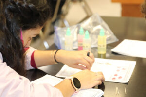 A student learns to find different blood types./ Hadley Hatch • Lowry Multimedia Communication