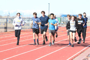 The Cross Country team running warmup laps. /Ron Espinola • The Brand