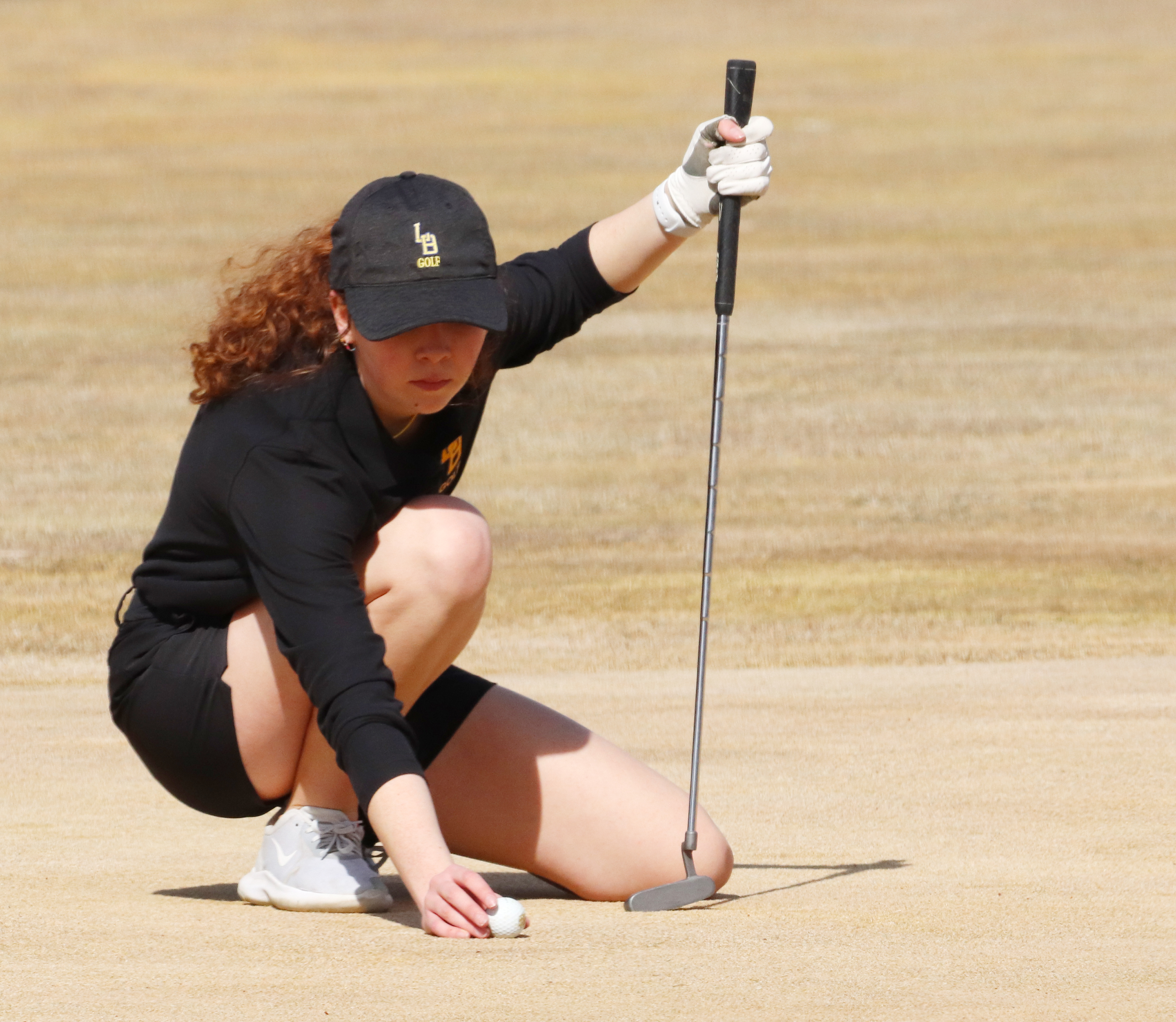 Bailey Hayes resets her ball for a putt. /Ron Espinola • The Brand