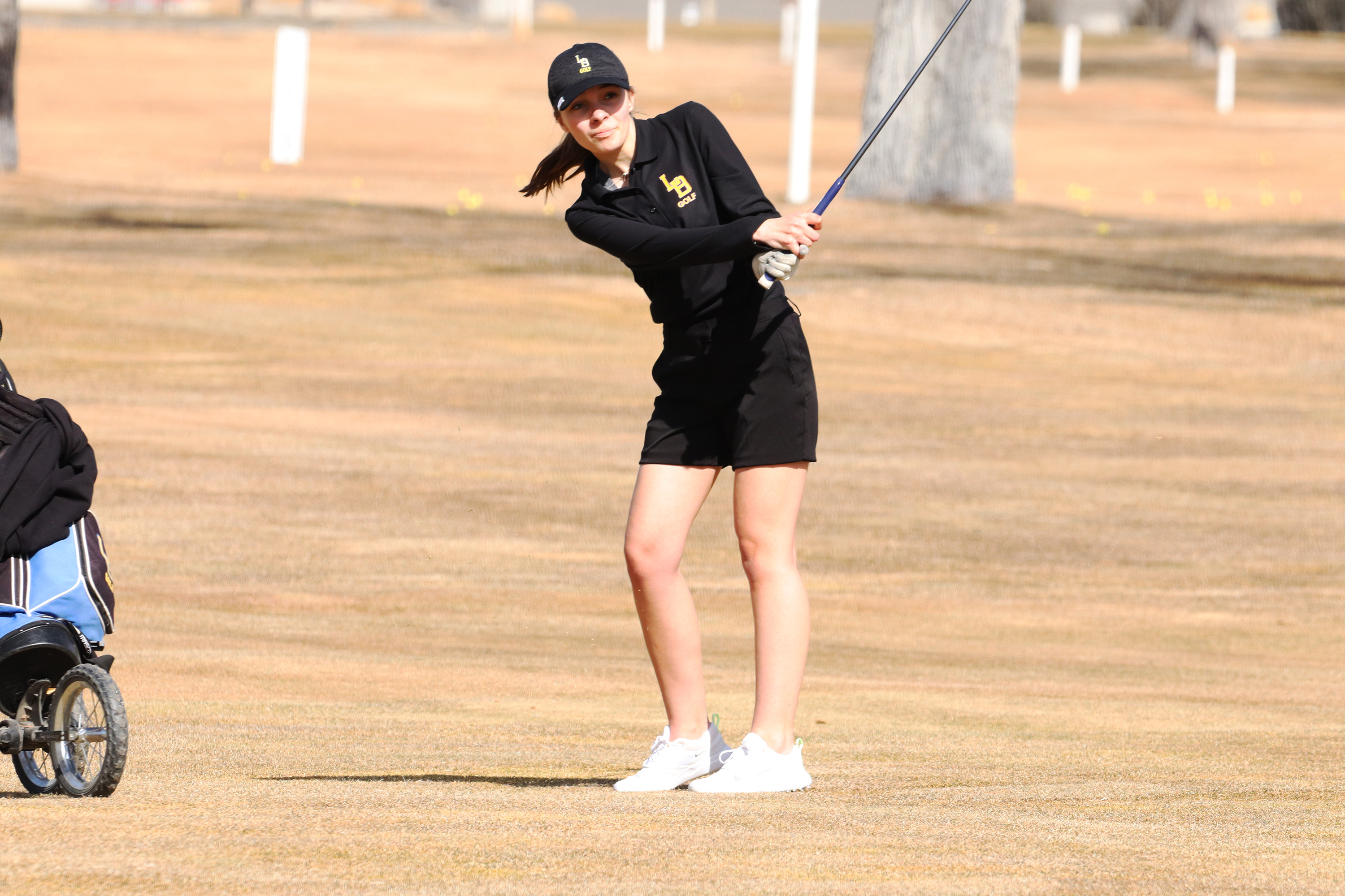 Kaitlyn Hales hits an approach shot from the fairway. /Ron Espinola • The Brand