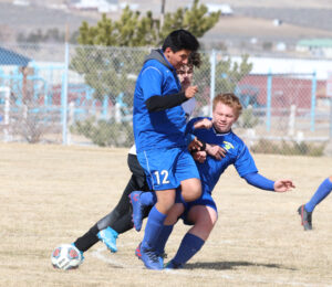 Nazareth Razo and Avery Wirthlin collide with a Fernley player. /Ron Espinola • The Brand