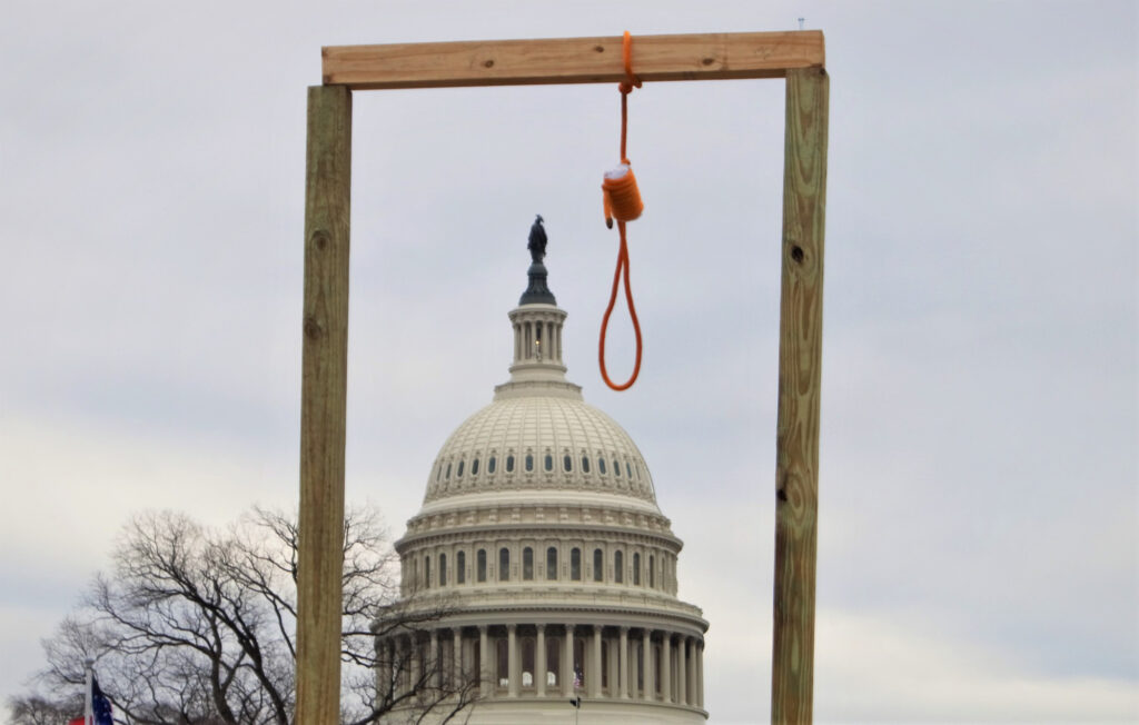 A gallows hangs near the United States Capitol during the 2021 storming of the United States Capitol on January 6, 2021. /Courtesy • Tyler Merbler from wikimedia