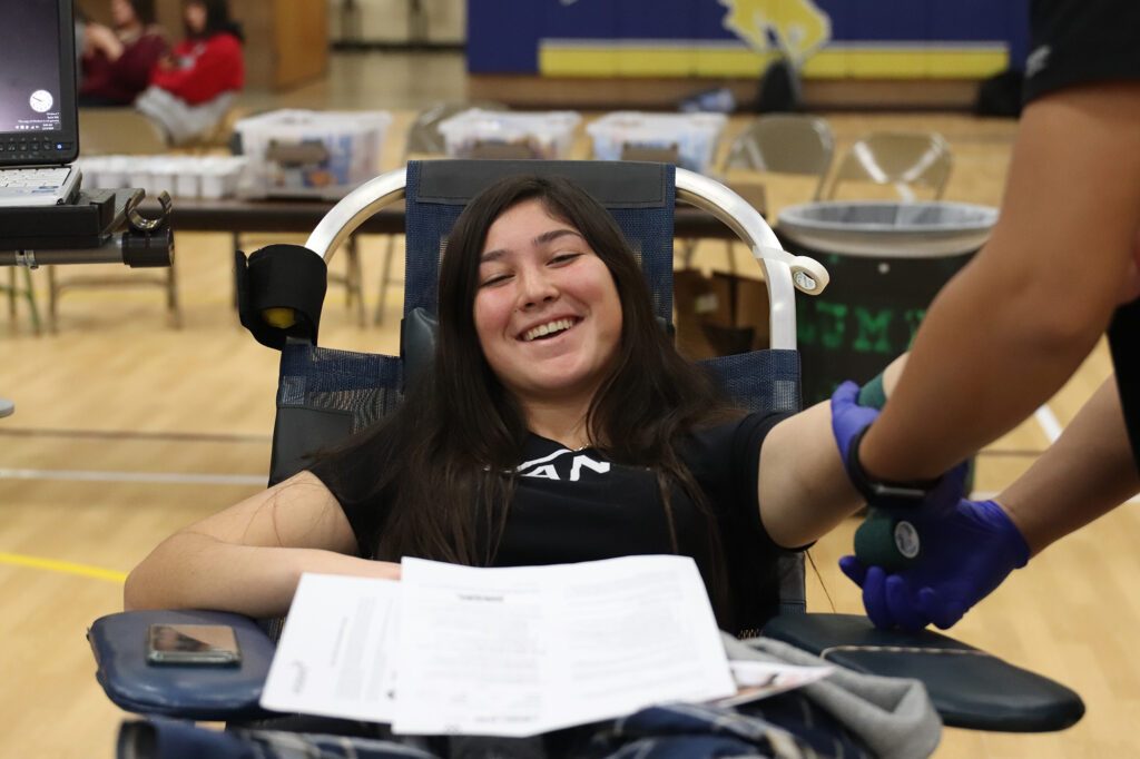Lesley Martinez gives blood at the blood drive./Mackie Grady • The Brand