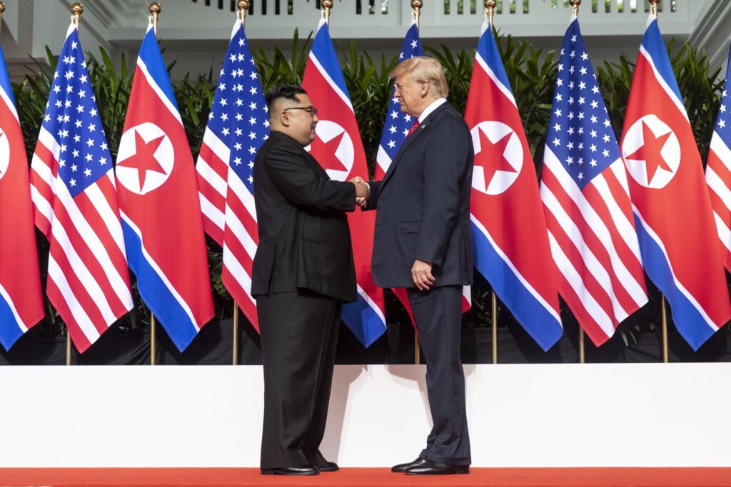 Kim and Trump shaking hands at the red carpet during the DPRK–USA Singapore Summit./Courtesy • Dan Scavino via wikimedia
