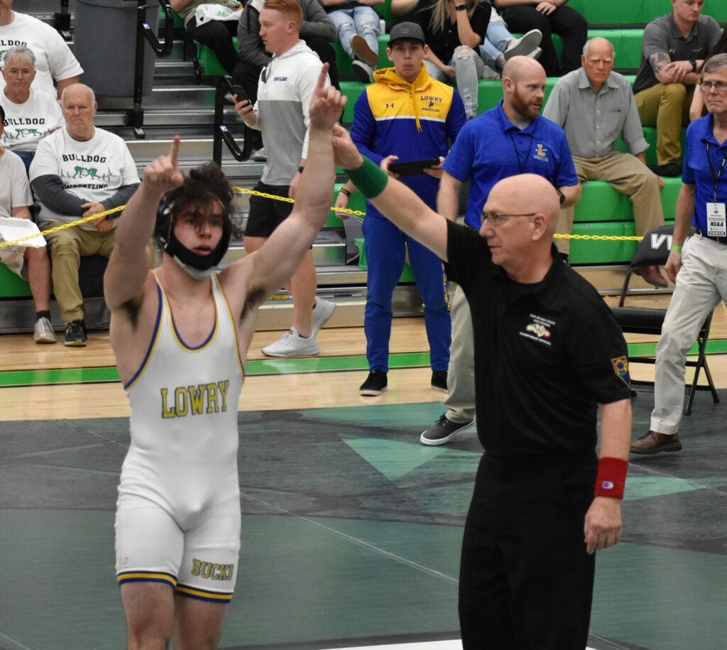 Anthony Peterson’s hand being raised by referee after winning state/.Courtesy • Alexis Mattson