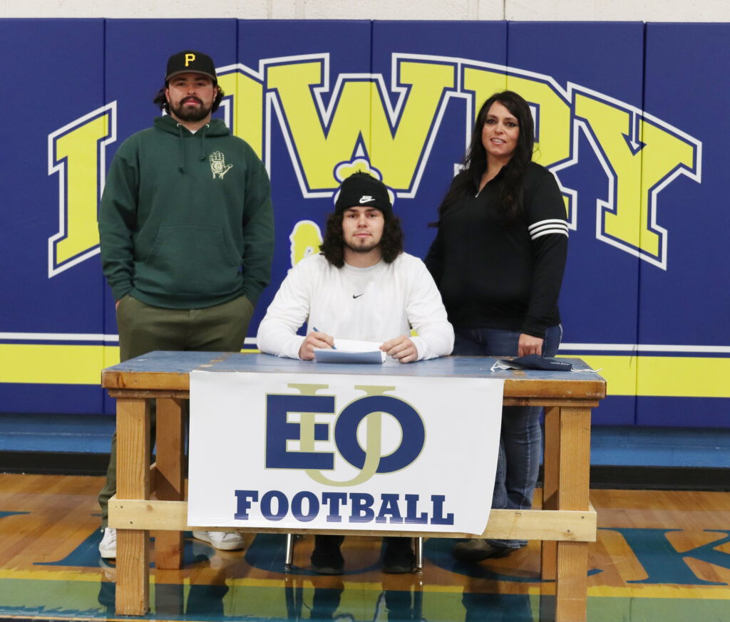 Anthony Peterson signing to Eastern Oregon University with his family. /Ron Espinola • The Brand