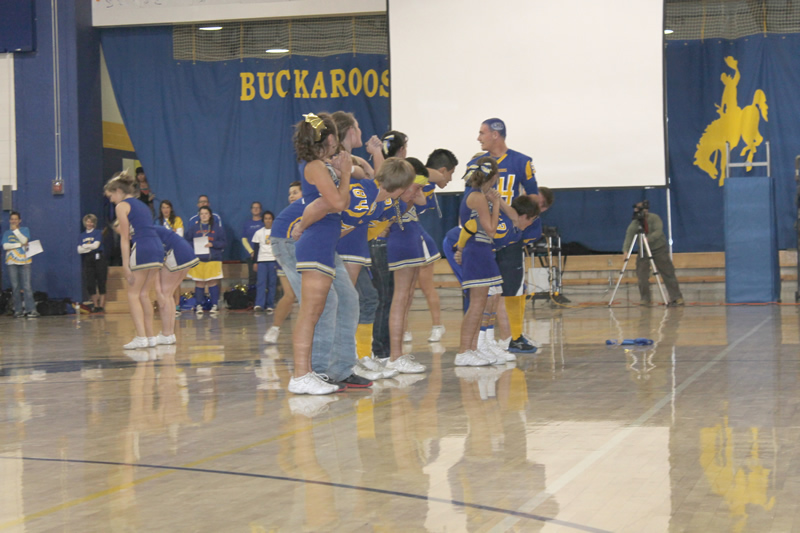Cheerleaders routine included the football players at the Friday pep assembly. /Harley Long • The Brand