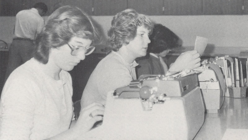 Back in the day (1980) these two hard working young women are typing away on old-fashioned, manual typewriters. /Courtesy • Winnada (1980)