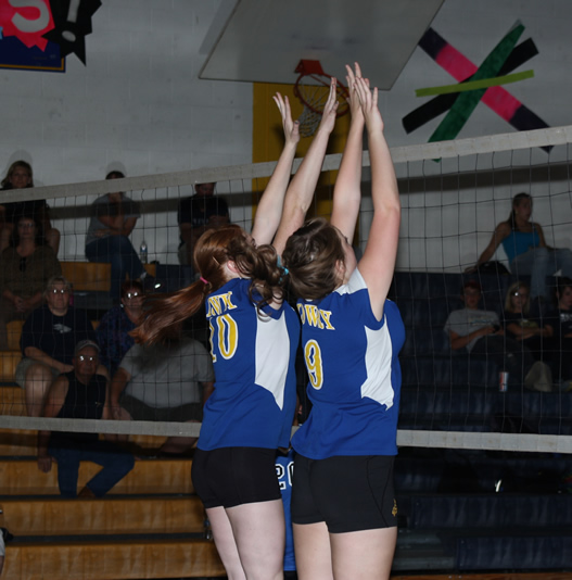 JV volleyball players try to block. /Brandon Eastman • The Brand