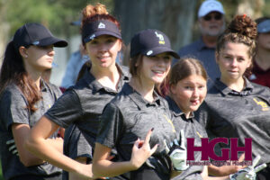 Bailey Hayes, Piper Nichols, Jordyn Medicine Cloud, and Presley Hayes all group together and pose at a golf tournament./ Alexis Galarza • The Brand