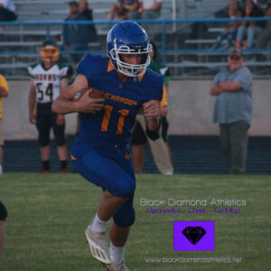 Number eleven Jordan Bills carries the football in a game against Battle Mountain. /Olivia Espinola • The Brand