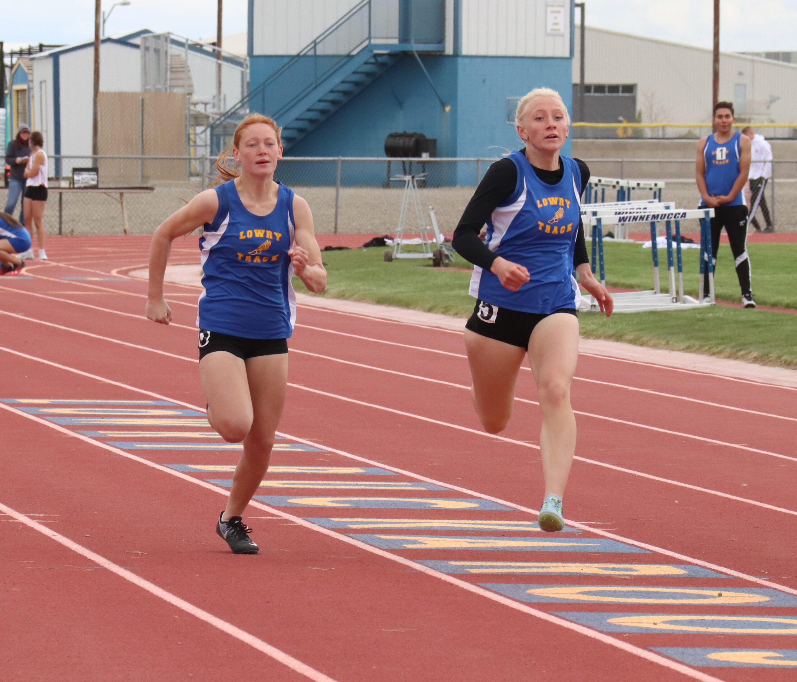 Sydnee Pettis and Emily Backus run at the Lowry Invitational Track Meet in 2022. /Maddi McClure • The Brand
