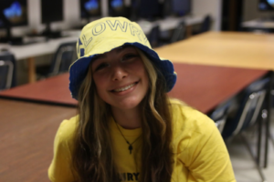 Isabel Upton smiles at the camera dressed in Lowry colors for the Prom spirit week on April 28, 2023. /Jovi Anderson • The Brand