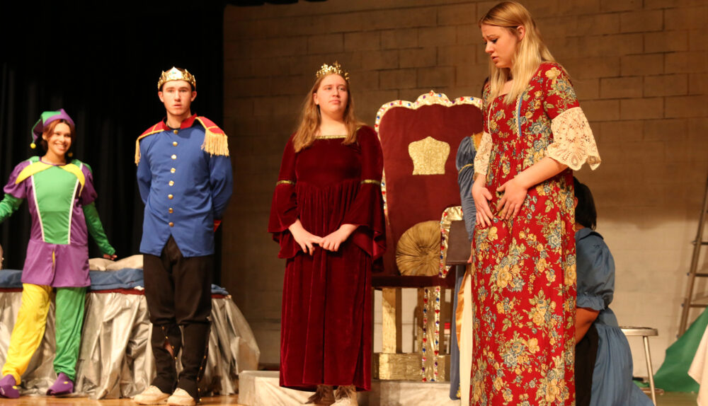 Kaylee Radtke (3rd from left) plays the Queen in the play “My Name is Rumpelstiltskin” / Ron Espinola • The Brand