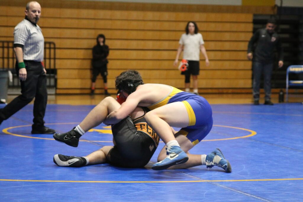 Brayden Dennis tries to put an opponent in a cradle at the 2023 senior night dual. /Yoci Perez • The Brand 