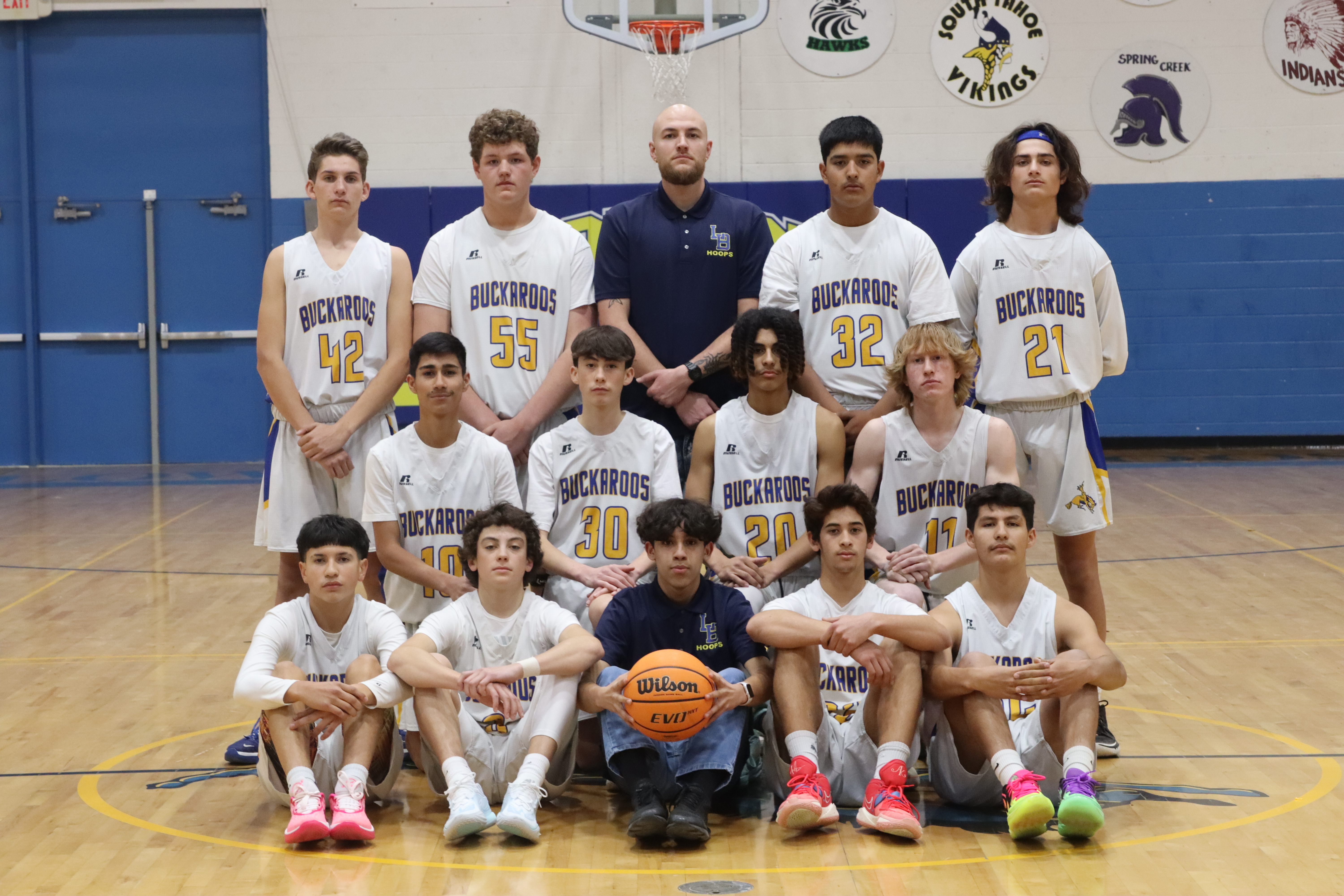 The JV boy’s basketball team smiles for their yearly team picture. /Olivia Espinola • The Brand