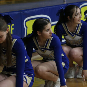 Aisys Herrera waits with her team during the sink it cheer./ Emily Valdez • The Brand