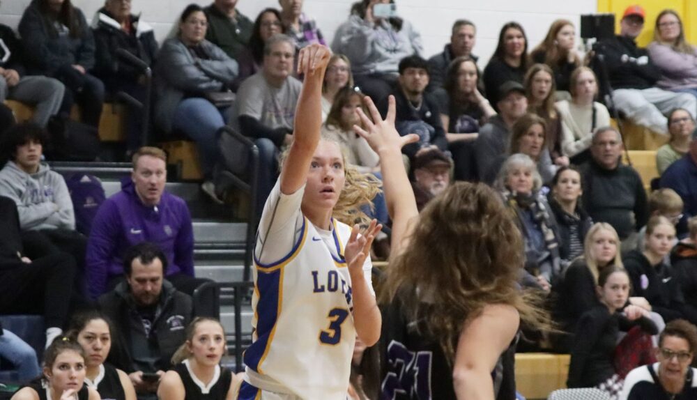 Bryce Brinkerhoff shoots a 3-pointer against her Spring Creek opponent. /Lainey Novacek • The Brand
