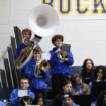 Martin Dockter, standing on the right ,plays the trumpet during a basketball game in the student section./ Ron Espinola • The Brand
