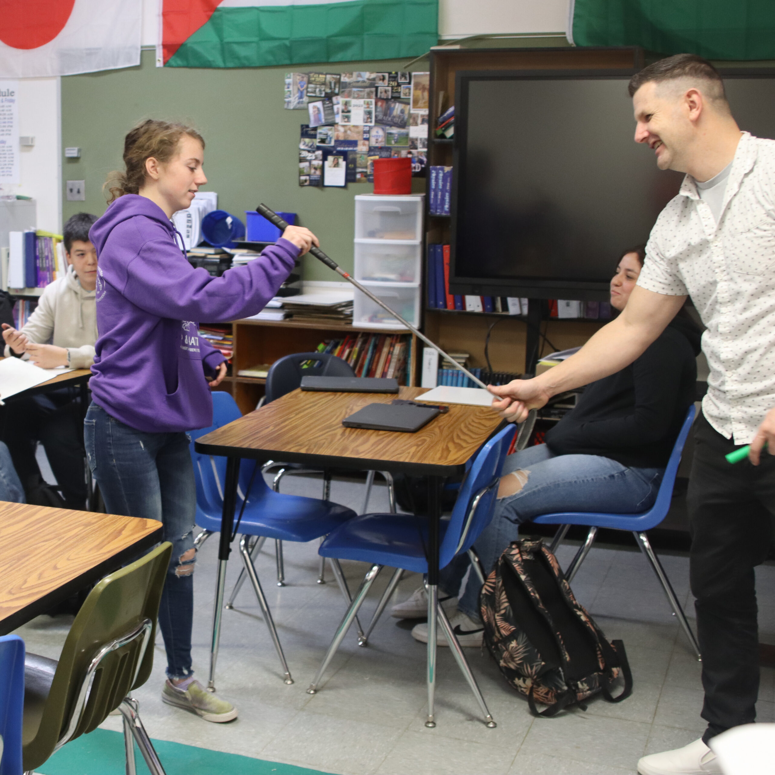 Mr. Clay Sagers helps a student in Spanish 2 show an example of the task at hand./ Addison Baker • The Brand 