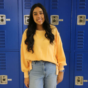 Luz Magaña poses for a picture in the hallway. /Madalynn Tagle • The Brand