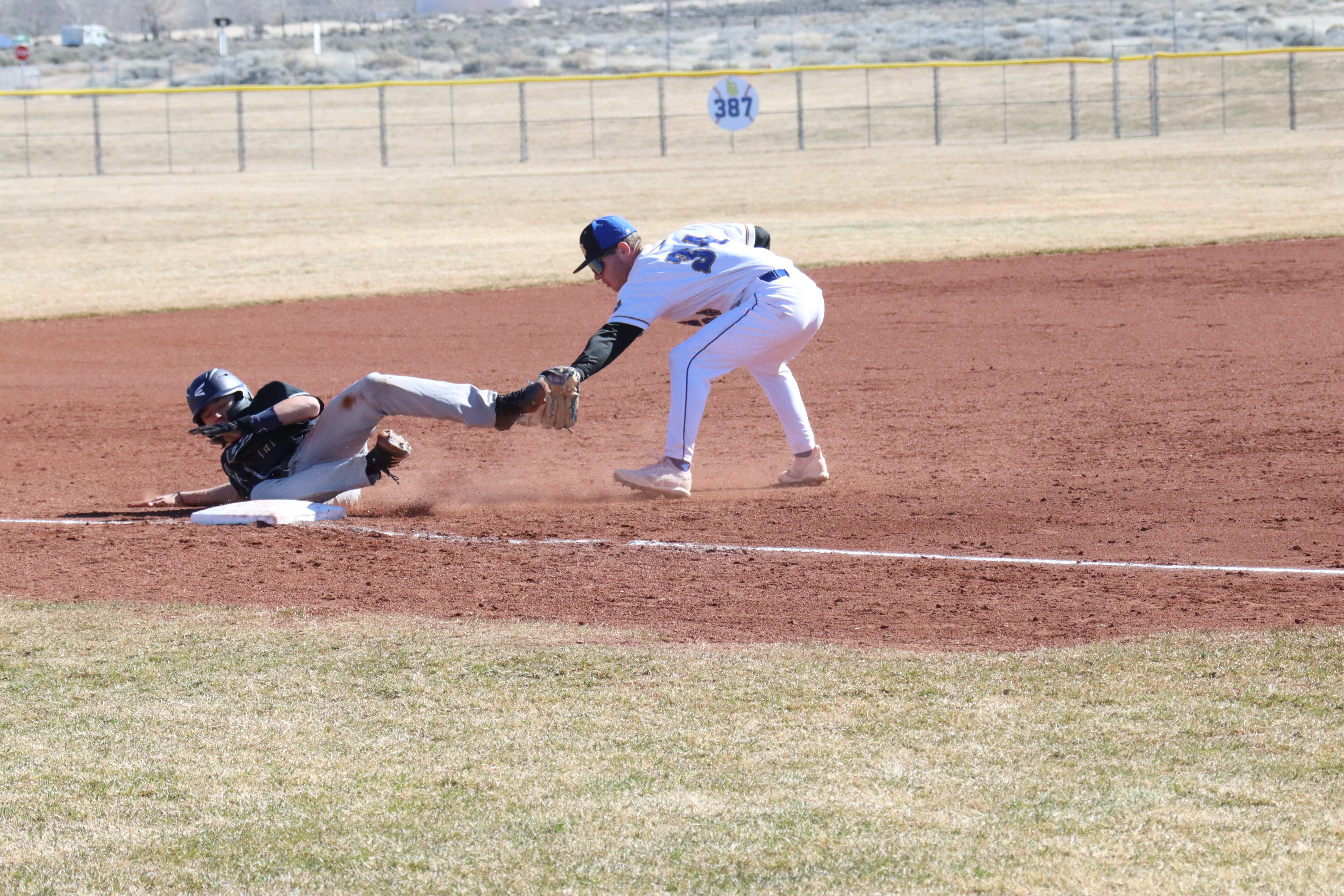 Adam Brooks tags out a runner at third base. /Olivia Espinola • The Brand