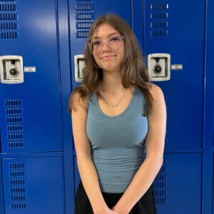 Melenna Messer poses for a photo in front of the lockers / Raegan Terry • The Brand