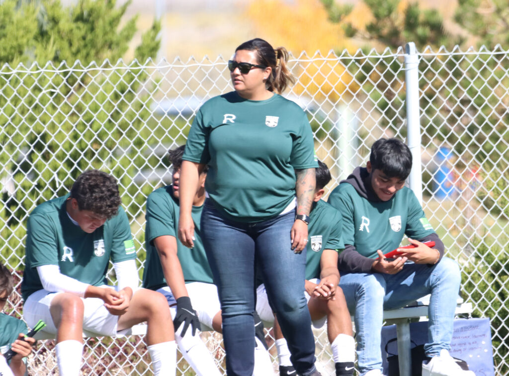 Coach Cristina Cuevas supports her athletes during the home game against West Wendover./ Olivia Espinola • The Brand