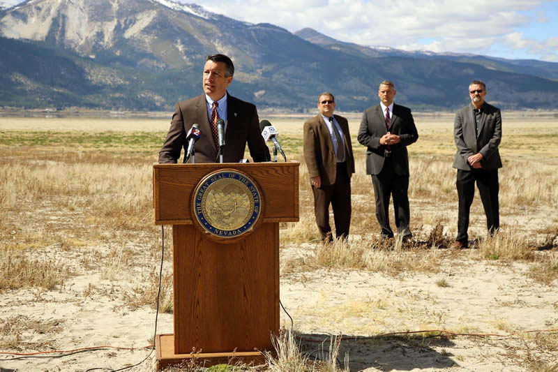 Governor Brian Sandoval speaks at a dry lake bed. /Courtesy •  https://dcnr.nv.gov/divisions-boards/nevada-drought-forum
