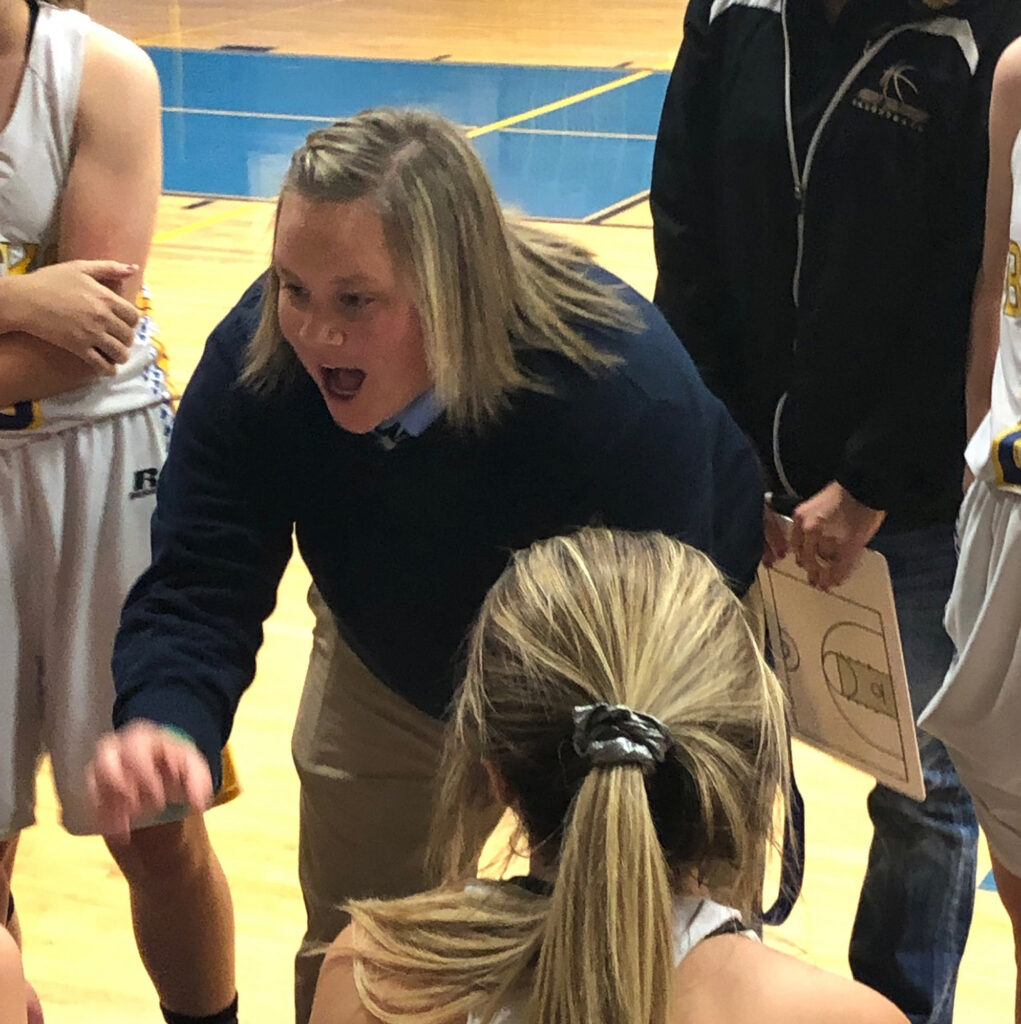 Coach Lynnsey talk to her team during a timeout. /Courtesy • Coach Lynnsey