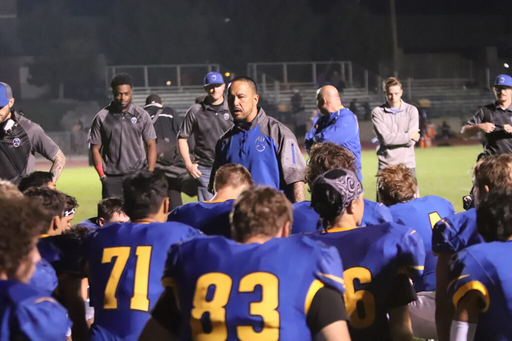 Coach Taua Cabatbat address his team after a game./ Ron Espinola • The Brand