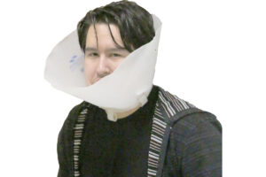 Demian wearing his restrictive cone./ Peyton Capellan • The Brand