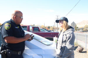 Officer Jones gives a "citation" to Cheyenne Koons. /Taylor Gleason • The Brand