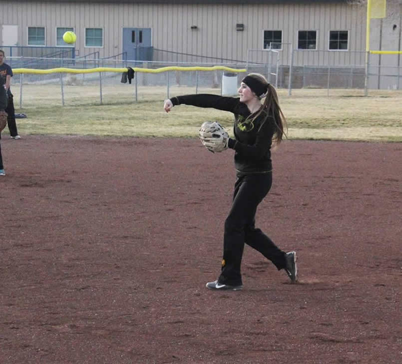 Senior Alyssa Dendary throws a softball at practice./ Brody Goucher •The Brand