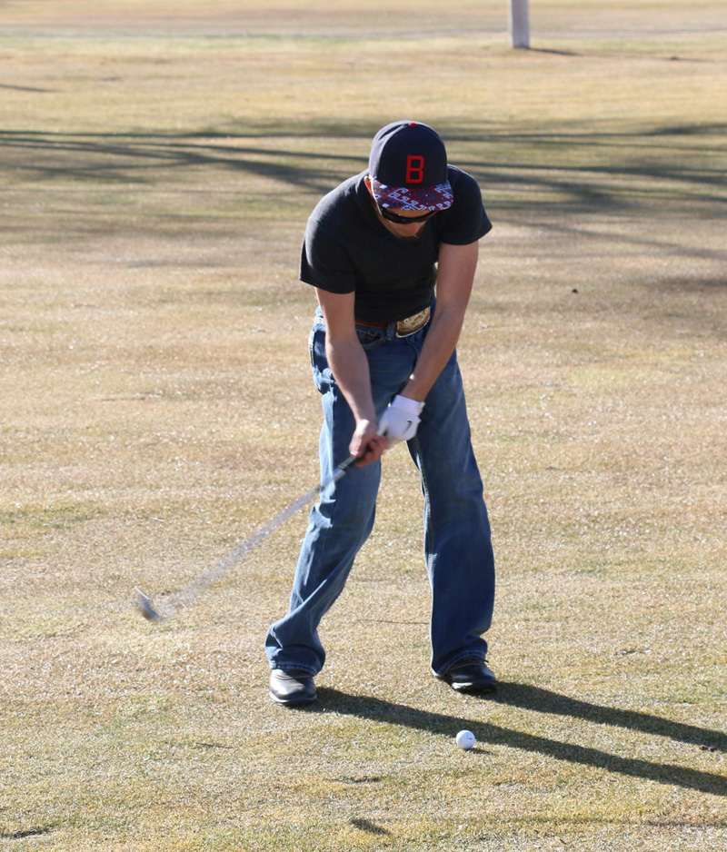 Freshman Seth Duncan hits the ball off of the fairway./Weston Irons • The Brand