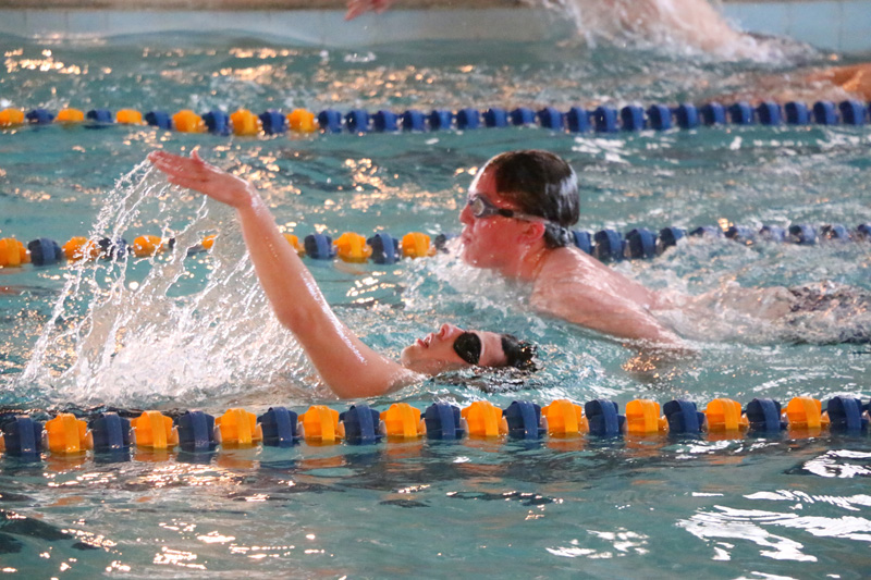 Nicholas Maddox swims a backstroke while Ian Maher swims a butterfly./ Weston Irons • The Brand