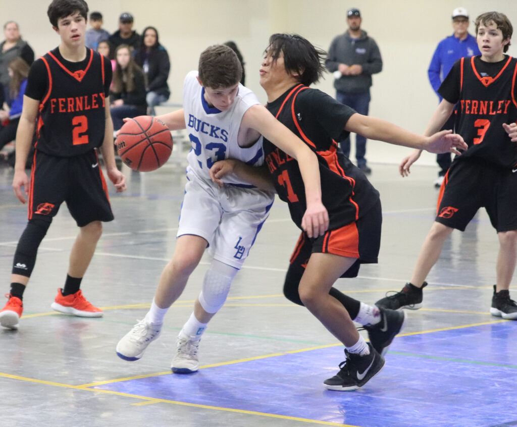 Drew Harmon drives by a defender./Ron Espinola • The Brand