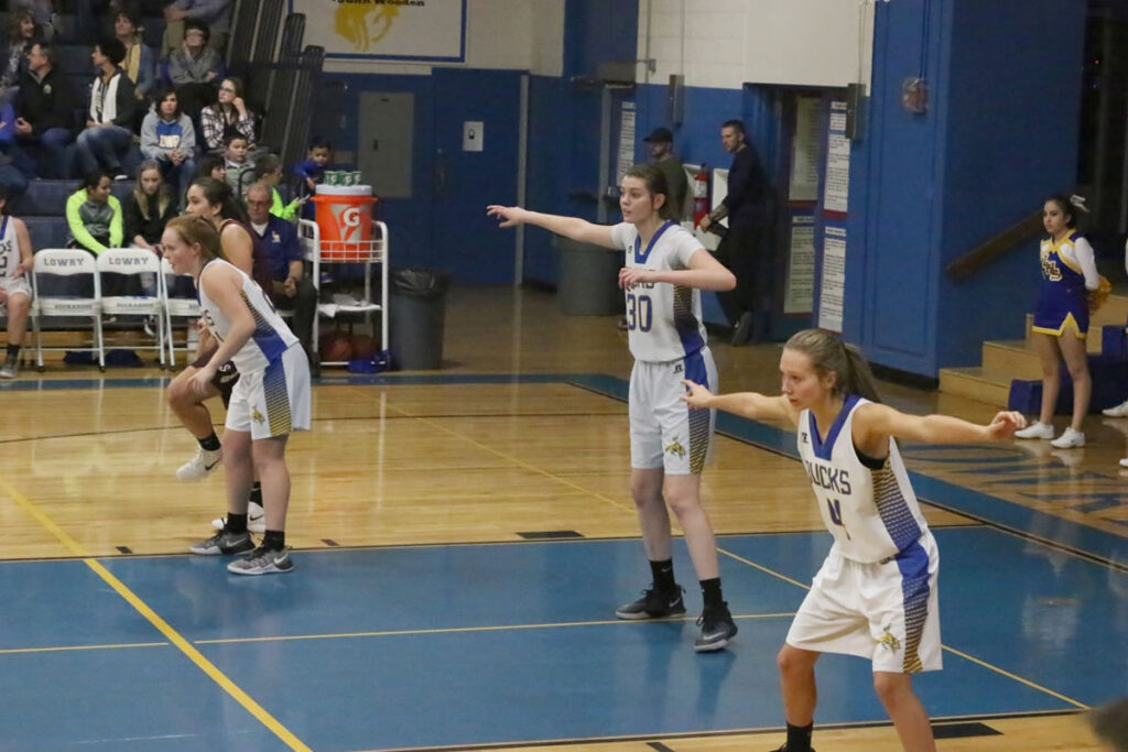 Sierra Maesterjuan, Brooke Hansen, and Rebecca Kuskie setting up their defensive play. /Ron Espinola • The Brand
