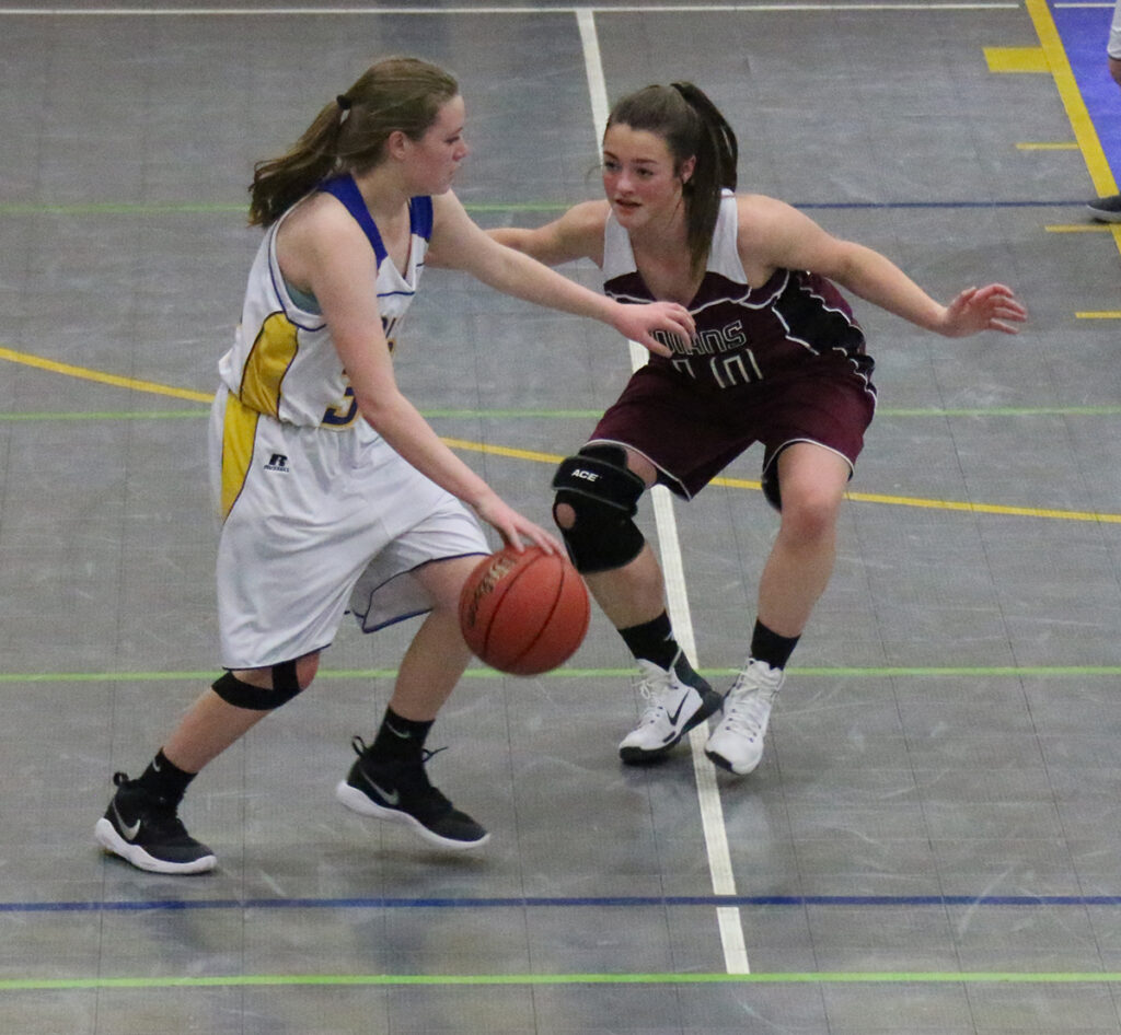 Kayla Lininger dribbling around an Elko player./Samm Sharp • The Brand