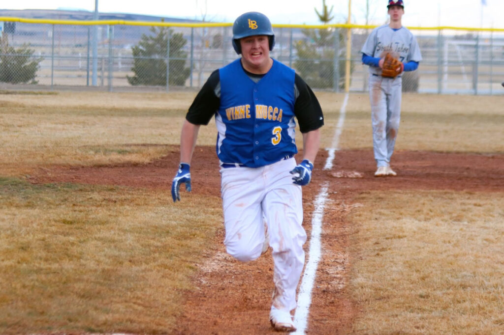 Jacob Marriot makes a break for home plate./Clarissa Olson • The Brand