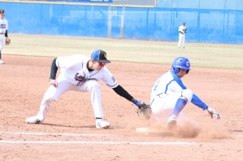 Klay Garner tags a runner at first base./Ron Espinola • The Brand